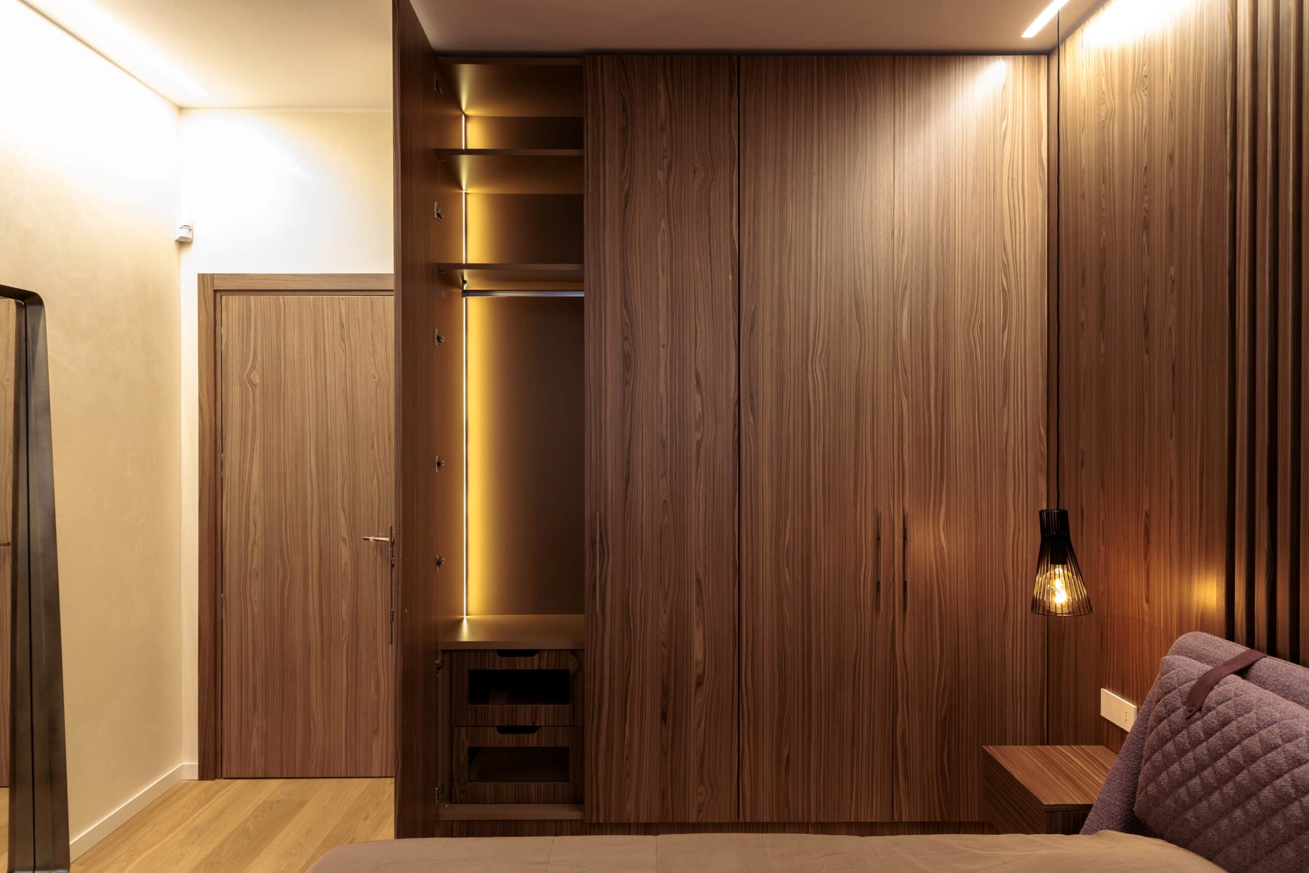 Custom walnut wardrobe with integrated lighting