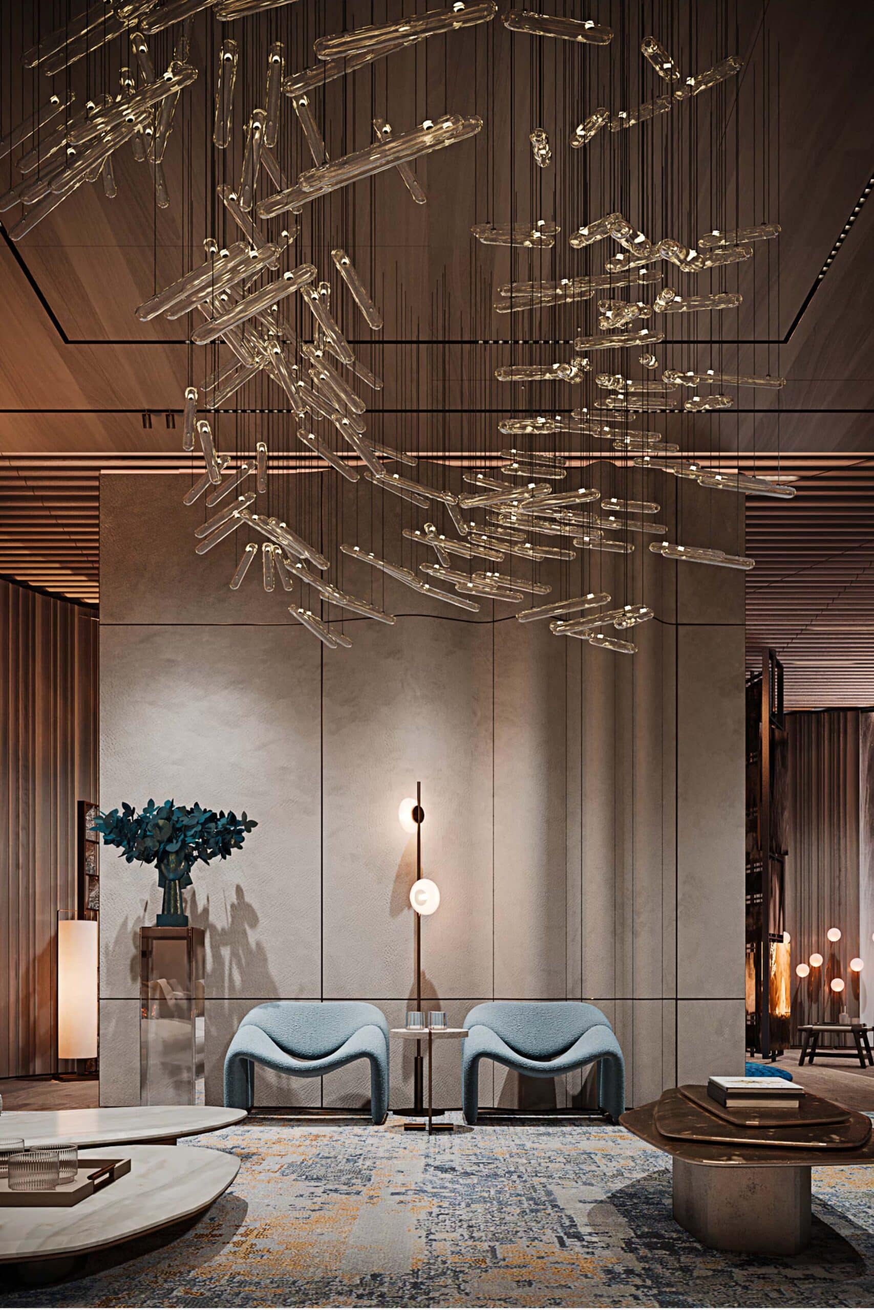 Lobby with a sculptural glass chandelier and light-blue armchairs